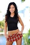 Sexy oriental hottie Rochelle Minami in tiny plaid skirt strips in her garden