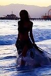The half naked Asian chick Kaila Yu is petted by the tender ocean waves