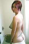 Amateur Asian model Gwen exposing hooters and tattoos in bathroom