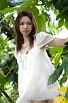 Hot and sexy brunette chick from Japan Yura Aikawa is sexily posing outdoors under the tree