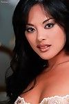 Lewd Asian babe Kaylani Lei is frisky enough to pose in white lingerie and press small tits.