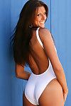Sweet cutie adores gently to remove her white suit and pose her bare body