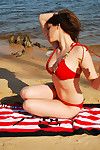 Engaging and attractive brunette teen with hawt figure is demonstrating her body on the beach