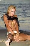 Slender fairy-haired hottie Natasha Marley shows her naughty parts in soggy sand on the beach