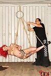 Tattooed redhead fetish model Becky Holt suspended by rope for BDSM shoot