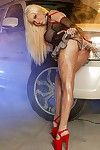 Leggy blonde Gina Lynn in red platform high heel shoes shows her big tits beside a limo