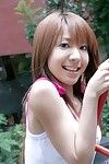 Merry Chinese hotty Yuuna Idols enjoys in teasing and lifting her t-shirt outdoor