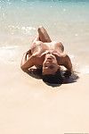 Undressed enormous breasted Japanese Tera Patrick shows off her sexiest body in sand on the beach