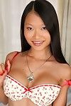 Slippy Japanese darling with round bosoms undressing and posing on the daybed
