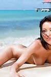 Moist uncovered Oriental Li Mei roams the beach as photos are snapped
