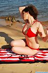 Winning and attracting brunette teen with sexy become available is demonstrating her body vulnerable a catch beach